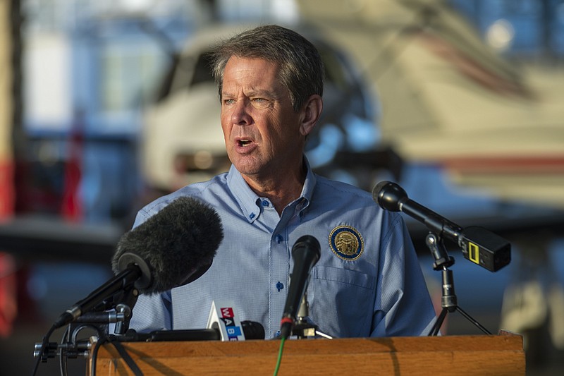 Gov. Brian Kemp speaks during a news conference at DeKalb-Peachtree Airport in Atlanta, Friday, Sept. 4, 2020.  Kemp and first lady Marty Kemp will take part in a fly-around tour of Georgia.  (Alyssa Pointer/Atlanta Journal-Constitution via AP)