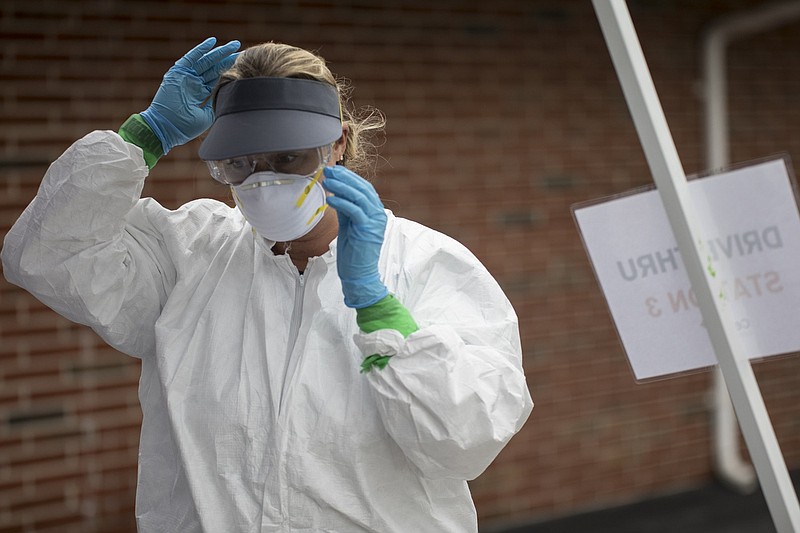 Staff photo by Troy Stolt / Clinician Amy Farlett Adjusts her PPE at a pop up test site being put on at the New Hope Baptist Church by Cempa Community care on Wednesday, May 27, 2020 in Chattanooga, Tenn. According to an updated report by the New York Times, Chattanooga currently ranks fourth in the country in highest average daily growth of new COVID-19 cases over the past two weeks, with 567 cases over that timeframe.