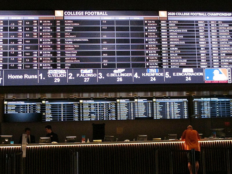 AP photo by Wayne Parry / A gambler places a bet at the sportsbook at Bally's casino on June 27, 2019, in Atlantic City, N.J. The NFL has narrowed the gap between itself and wagering in recent years, with a big moving coming this past May when teams were cleared to sign sponsorship deals with gambling entities.