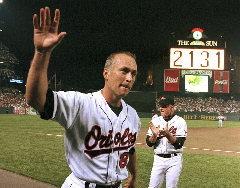 AP photo by Denis Paquin / Baltimore Orioles shortstop Cal Ripken Jr. waves to the crowd as the sign in center field at Baltimore's Camden Yards reads 2,131, signifying Ripken had broken Lou Gehrig's MLB record of 2,130 consecutive games played on Sept. 6, 1995.