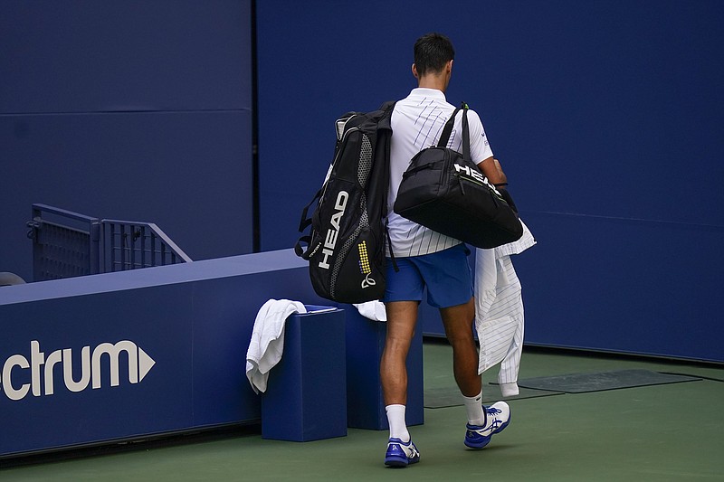 AP photo by Seth Wenig / Novak Djokovic leaves the court after being defaulted from his fourth-round match with Pablo Carreno Busta on Sunday at the U.S. Open in New York.