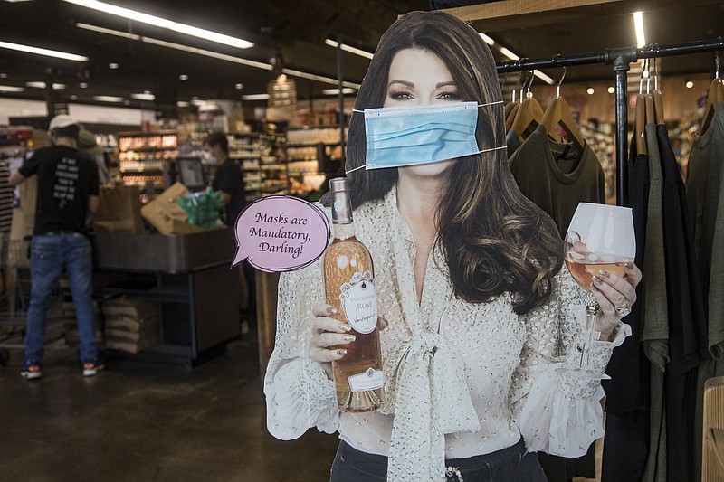 Staff photo by Troy Stolt / A cut out that says "Masks are Mandatory, Darling" is seen at the entrance of Pruett's Market on Friday, Sept. 4, 2020 in Signal Mountain, Tenn.