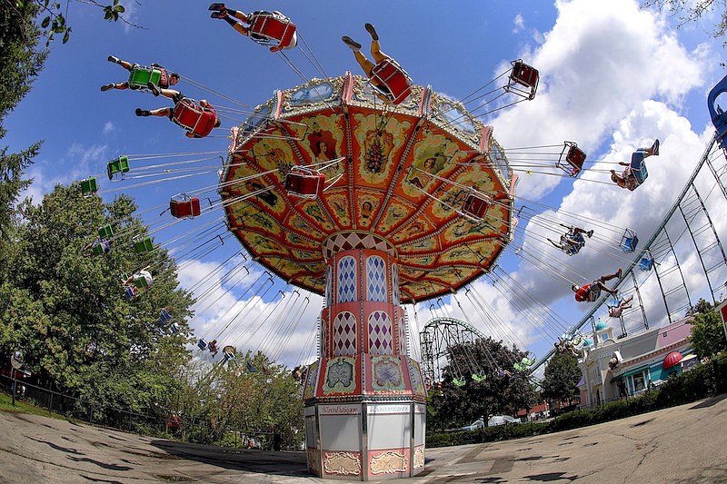 In this photo made on Saturday, Aug. 29, 2020, visitors ride the Wave Swinger in the "Lost Kennywood" section of Kennywood Park in West Mifflin, Pa. Visitors have been slow to return to U.S. theme parks that saw their seasons interrupted by the coronavirus crisis, causing some parks to reduce their operating days, slash ticket prices and close early for the year. (AP Photo/Keith Srakocic)