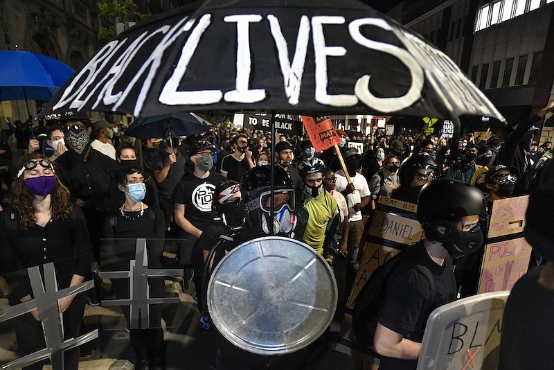 Demonstrators march through the streets in Rochester, N.Y., Friday, Sept. 4, 2020 protesting the death of Daniel Prude. Prude apparently stopped breathing as police in Rochester were restraining him in March 2020 and died when he was taken off life support a week later. (AP Photo/Adrian Kraus)