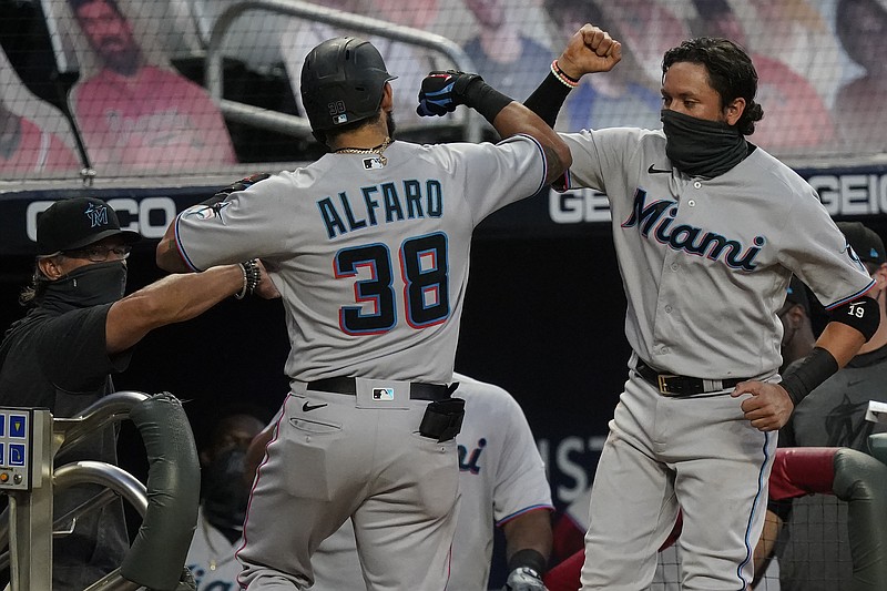 AP photo by Brynn Anderson / Miami Marlins teammates Jorge Alfaro, left, and Miguel Rojas celebrate after Alfaro hit a home run during the third inning of Tuesday's game against the host Atlanta Braves.