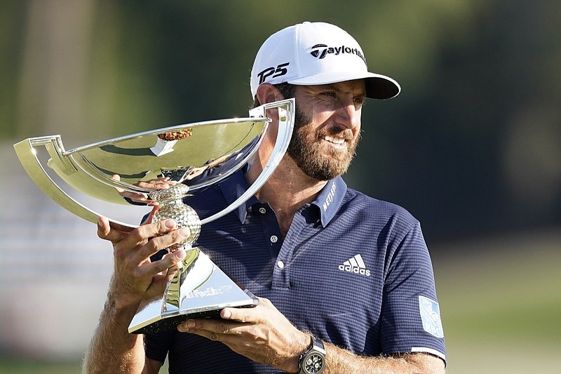 AP photo by John Bazemore / Dustin Johnson holds up the FedEx Cup trophy after winning the Tour Championship on Monday at East Lake Golf Club in Atlanta. It was the finale for the PGA Tour's 2019-20 season.