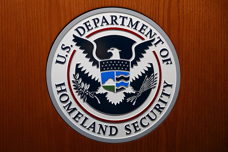 In this June 28, 2019, file photo the Department of Homeland Security (DHS) seal is seen during a news conference in Washington. An official at the Department of Homeland Security says he was pressured by agency leaders to suppress details in his intelligence reports that President Donald Trump might find objectionable, including intelligence on Russian interference in the election and the threat posed by white supremacists. (AP Photo/Carolyn Kaster, File)