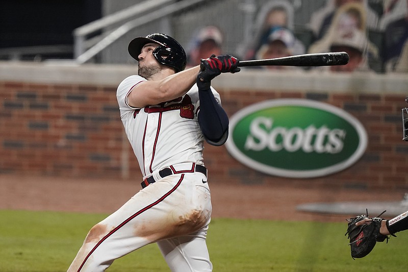 AP photo by Brynn Anderson / Atlanta's Adam Duvall hits a home run in the fifth inning of Wednesday night's 29-9 home win against the Miami Marlins. Duvall hit three homers in the game, including a grand slam, and drove in nine runs for the Braves as they bounced back from a 8-0 loss to Miami on Tuesday.
