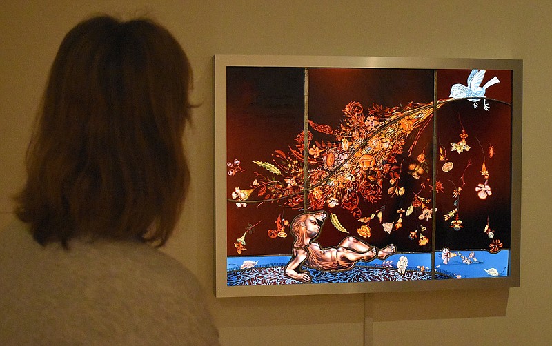 Staff Photo by Matt Hamilton / Cara McGowan, left, director of marketing and communications for the Hunter Museum of American Art, looks at a piece on display titled "Efflorescence," a stained-glass work by artist Judith Schaechter. It's among the works in "The F Word: We Mean Female!," which continues through Jan. 10, 2021.