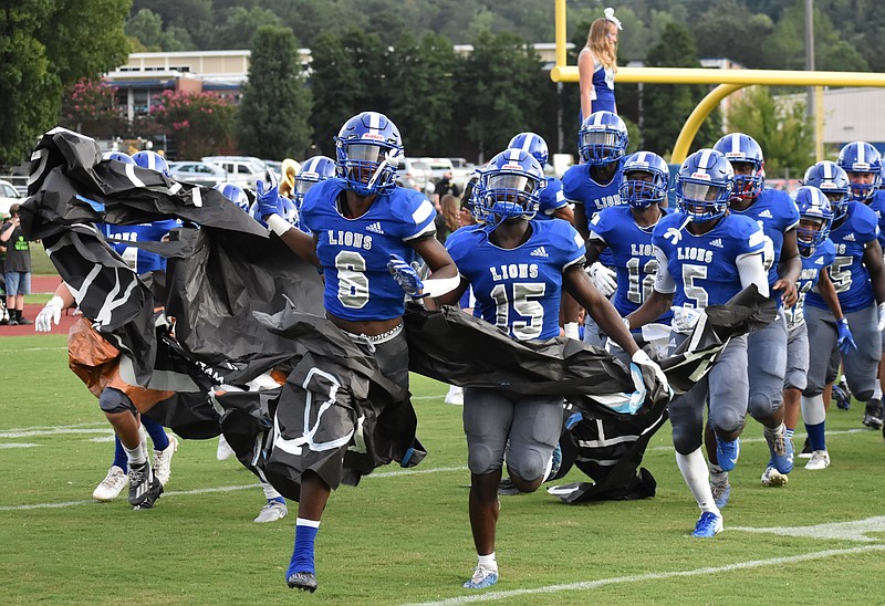 Staff photo by Patrick MacCoon / Red Bank players sprint onto the field before Friday night's 27-24 victory over East Hamilton in a battle of state-ranked teams.