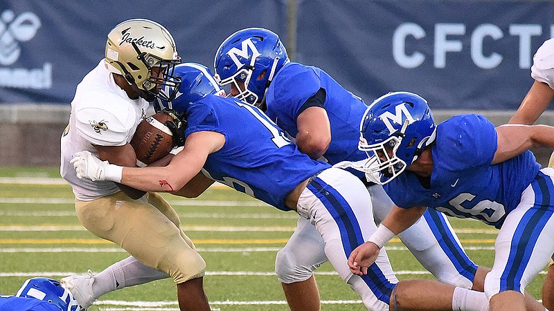 Staff photo by Matt Hamilton / McCallie defenders swarm Calhoun running back Jerrian Hames during Friday night's game at Finley Stadium. McCallie won 38-22 thanks to a decisive stretch early in the fourth quarter.