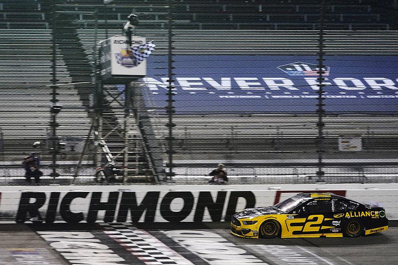 AP photo by Steve Helber / Brad Keselowski crosses the finish line to win Saturday night's NASCAR Cup Series race in Richmond, Va.