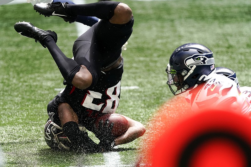 AP photo by John Bazemore / Atlanta Falcons receiver Russell Gage ends up on his helmet as he makes a catch during the first half of Sunday's season-opening game against the visiting Seattle Seahawks. Gage was one of three Falcons with nine catches for more than 100 yards, but Atlanta still lost 38-25.