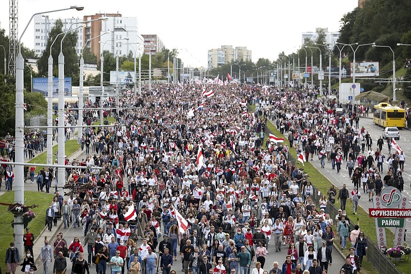 Protesters with old Belarusian national flags march during a Belarusian opposition supporters' rally protesting the official presidential election results in Minsk, Belarus, Sunday, Sept. 13, 2020. Protests calling for the Belarusian president's resignation have broken out daily since the Aug. 9 presidential election that officials say handed him a sixth term in office. (TUT.by via AP)