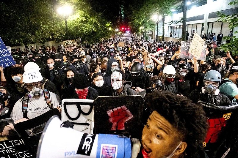 Associated Press File Photo / Protests like this one in August in Portland, Oregon, often sported signs displaying a swastika and President Trump's photo or name.