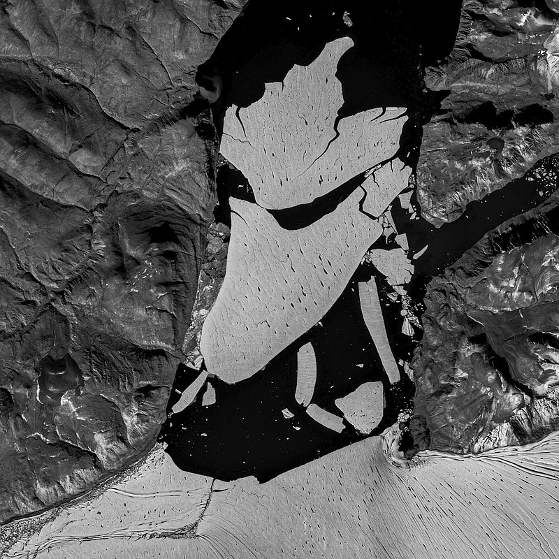 In this image proved by the European Space Agency, ESA, showing the glacier section that broke off the fjord called Nioghalvfjerdsfjorden, bottom, which is roughly 80 kilometers (50 miles) long and 20 kilometers (12 miles) wide, the National Geological Survey of Denmark and Greenland said Monday Sept. 14, 2020. The glacier is at the end of the Northeast Greenland Ice Stream, where it flows off land and into the ocean. Scientists with National Geological Survey see it as evidence of rapid climate change leading to the disintegration of the Arctic's largest remaining ice shelf. (European Space Agency via AP)