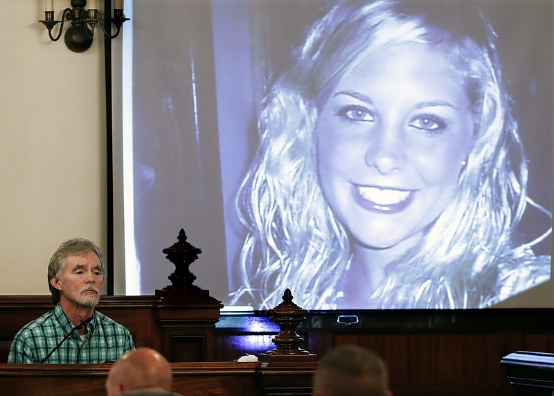 In this Sept. 11, 2017 file photo, Dana Bobo, let, father of Holly Bobo testifies in the trial of Zachary Adams as a photo of Holly Bobo is displayed in Savannah, Tenn. Jason Autry pleaded guilty Monday, Sept. 14, 2020 to taking part in the killing of Tennessee nursing student Holly Bobo more than nine years ago, but he is expected to be released soon as part of a deal with prosecutors. (AP Photo/Mark Humphrey, Pool, File)