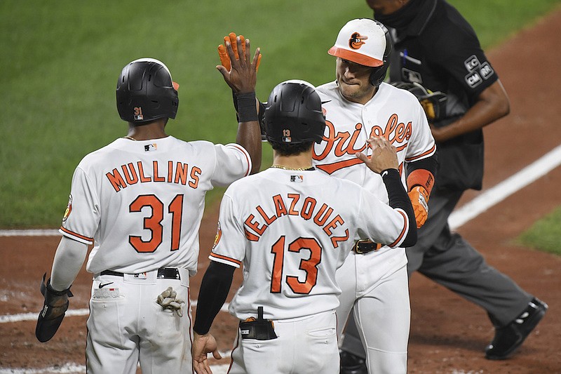 Baltimore Orioles' Jose Iglesias, right, celebrates his home run with Cedric Mullins (31) and Andrew Velazquez (13) during the third inning of a baseball game against the Atlanta Braves, Monday, Sept. 14, 2020, in Baltimore. (AP Photo/Terrance Williams)