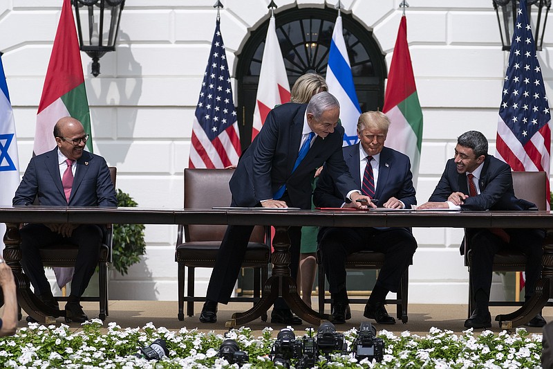 Photo by Alex Brandon of The Associated Press / Bahrain Foreign Minister Khalid bin Ahmed Al Khalifa, left, Israeli Prime Minister Benjamin Netanyahu, President Donald Trump, and United Arab Emirates Foreign Minister Abdullah bin Zayed al-Nahyan look at the documents during the Abraham Accords signing ceremony on the South Lawn of the White House on Tuesday, Sept. 15, 2020, in Washington.