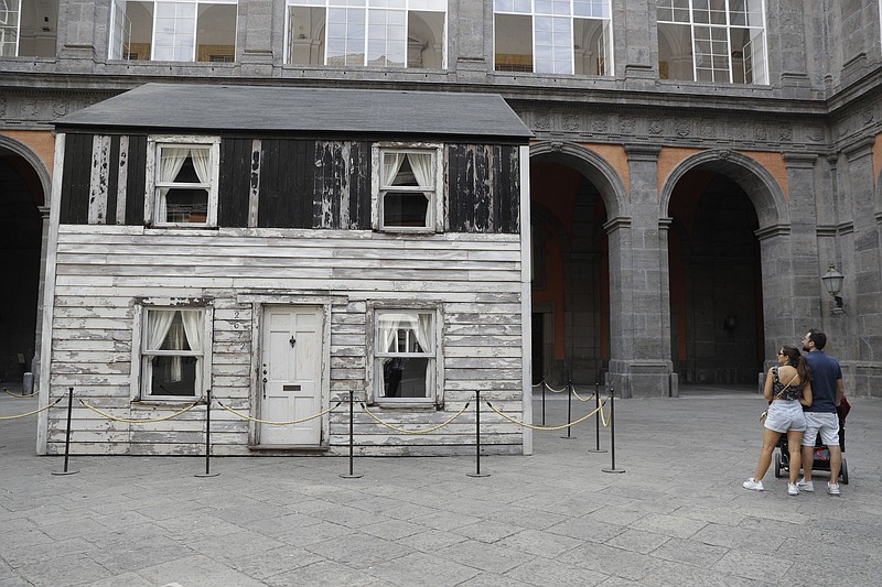 The house of U.S. civil rights campaigner Rosa Parks, rebuilt by artist Ryan Mendoza, is on display in the courtyard of an 18th century Royal Palace, in Naples, Italy, Tuesday, Sept. 15, 2020. It's the latest stop for the house in a years-long saga that began when Parks' niece saved the tiny two-story home from demolition in Detroit after the 2008 financial crisis. (AP Photo/Gregorio Borgia)