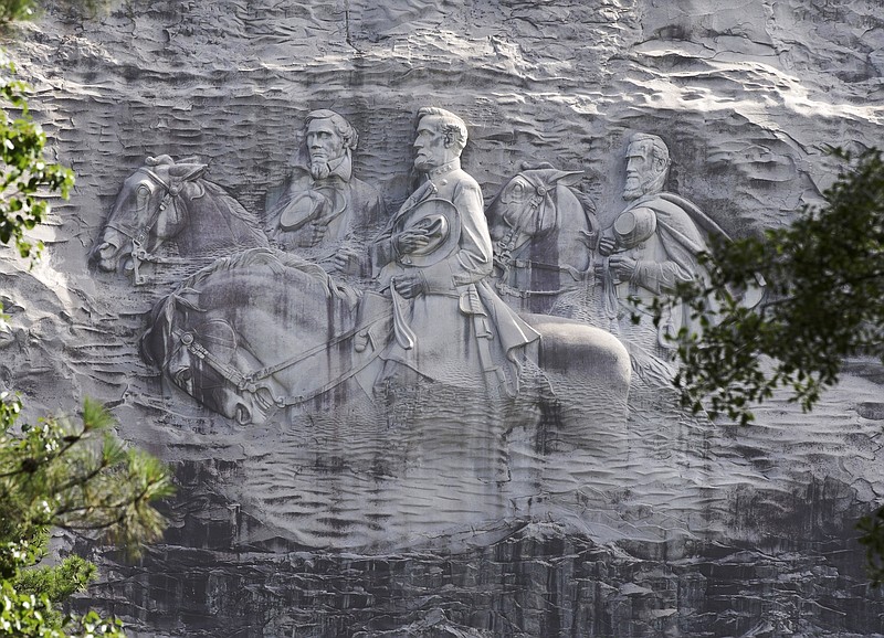 This June 23, 2015, file photo shows a carving depicting Confederate Civil War figures Stonewall Jackson, Robert E. Lee and Jefferson Davis, in Stone Mountain, Ga. An activist group has presented its plans for changes to Confederate imagery at Georgia's popular Stone Mountain Park, including a suggestion that it stop maintaining a colossal sculpture of Confederate leaders. Members of the Stone Mountain Action Coalition spoke Monday, Sept. 14, 2020, at a meeting with board members of the association responsible for the park, the Atlanta Journal-Constitution reported. (AP Photo/John Bazemore, File)