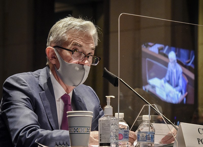 FILE - In this June 30, 2020, file photo Federal Reserve Board Chairman Jerome Powell, reflected in the sneeze guard set up between himself and members of the House Committee on Financial Services, speaks during a hearing on oversight of the Treasury Department and Federal Reserve pandemic response on Capitol Hill in Washington. The Federal Reserve adjusted its inflation target to seek price increases above 2% annually, a move that will likely keep interest rates low for years to come. The Fed on Wednesday, Sept. 16, also left its benchmark short-term rate unchanged at nearly zero, where it has been since the pandemic intensified in March. (Bill O'Leary/The Washington Post via AP, Pool)