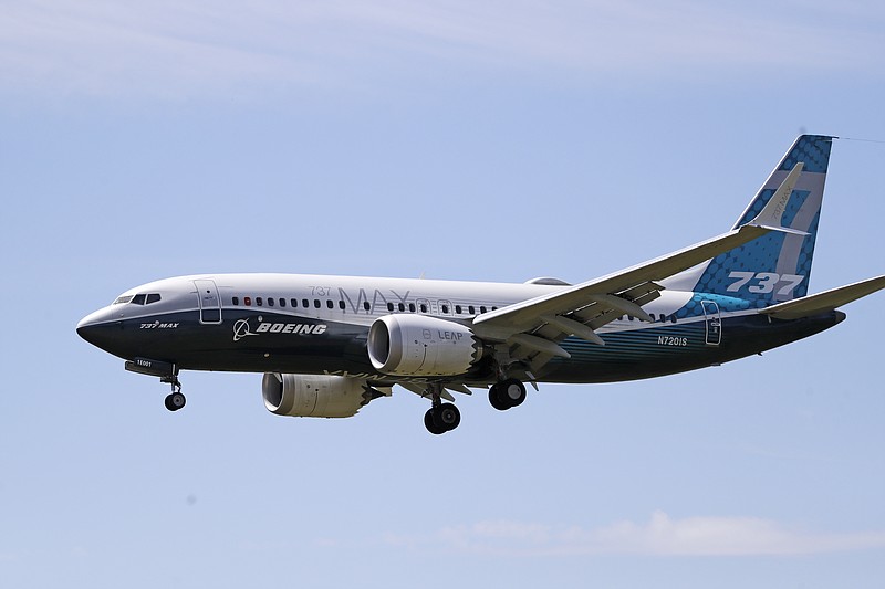 In this Monday, June 29, 2020, file photo, a Boeing 737 Max jet heads to a landing at Boeing Field following a test flight in Seattle. A U.S. House committee is questioning whether Boeing and the Federal Aviation Administration have recognized problems that caused two deadly 737 Max jet crashes and if either organization will be willing to make significant changes to fix them. (AP Photo/Elaine Thompson, File)
