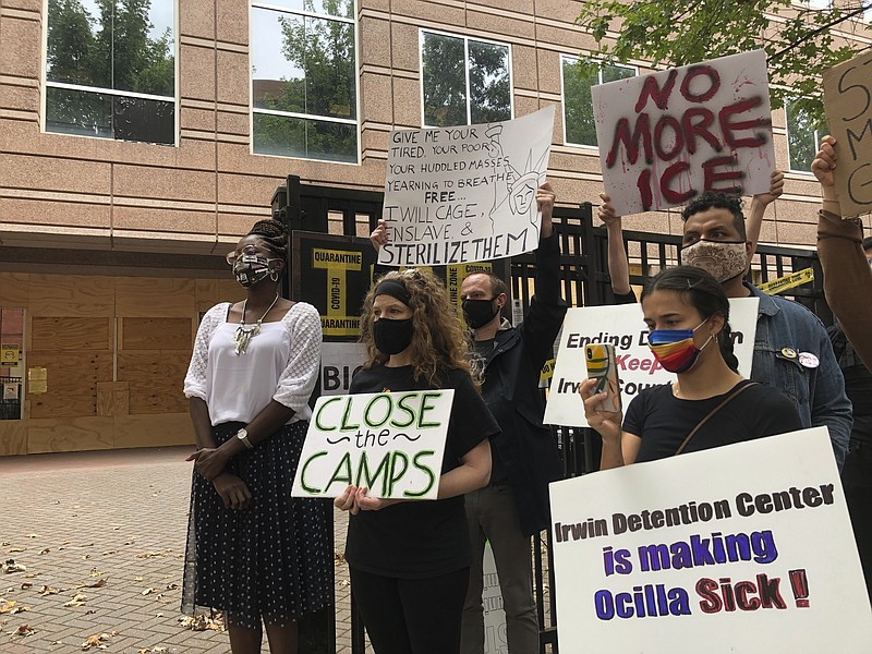 In this Tuesday, Sept. 15, 2020, file photo, Dawn Wooten, left, a nurse at Irwin County Detention Center in Ocilla, Georgia, speaks at a news conference in Atlanta protesting conditions at the immigration jail. An Associated Press review of medical records for four detained immigrant women at the detention center and interviews with lawyers have revealed growing allegations that a gynecologist performed surgeries that the women never sought or didn't fully understand. (AP Photo/Jeff Amy, File)