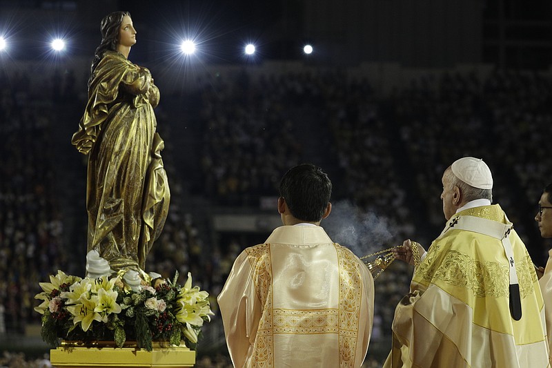 In this Nov. 21, 2019 file photo, Pope Francis blesses a statue of the Mother Mary as he celebrates Mass at the National Stadium, in Bangkok, Thailand. Pope Francis is giving his blessing to a new Vatican think tank that is seeking to prevent the Mafia and organized crime groups from exploiting the image of the Virgin Mary for their own illicit ends. (AP Photo/Gregorio Borgia)