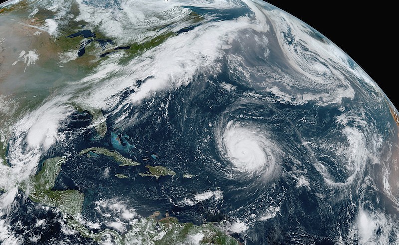 This GOES-16 GeoColor satellite image taken Friday, Sept. 18, 2020, at 12:20 p.m. EDT., and provided by NOAA, shows Hurricane Teddy, center, in the Atlantic, Tropical Depression 22, left, in the Gulf of Mexico, the remnants Paulette, top right, and Tropical Storm Wilfred, lower right. Forecasters have run out of traditional names for the Atlantic hurricane season. Tropical Storm Wilfred, the last of traditional names, officially formed little more than an hour before subtropical storm Alpha, prompting the hurricane center to tweet "get out the Greek alphabet." (NOAA via AP)