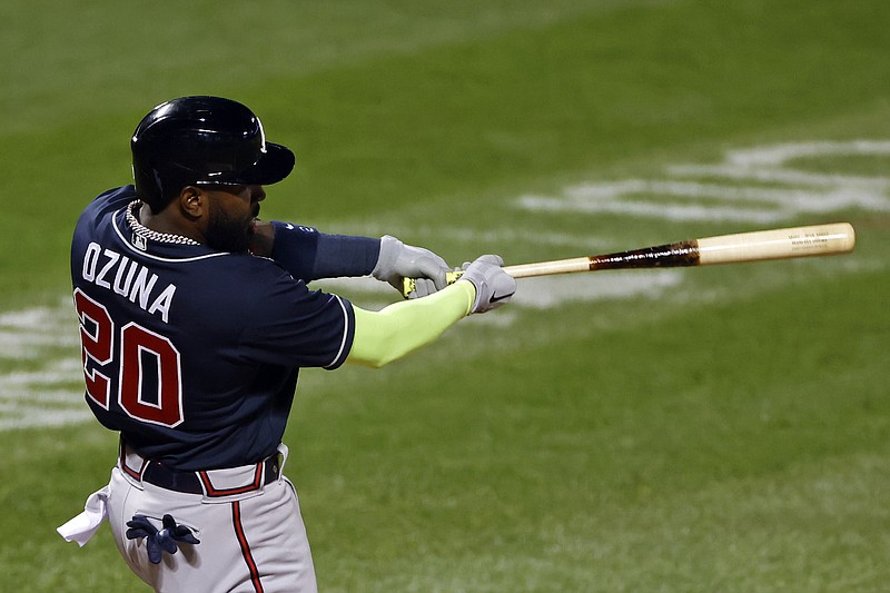 FILE: AP photo by Adam Hunger / Atlanta Braves designated hitter Marcell Ozuna slugs a three-run homer during the second inning of a game against the New York Mets.