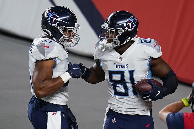 AP photo by Jack Dempsey / Tennessee Titans tight end Jonnu Smith (81) celebrates his touchdown catch with running back Khari Blasingame during the second half of last Monday's season-opening win against the host Denver Broncos.