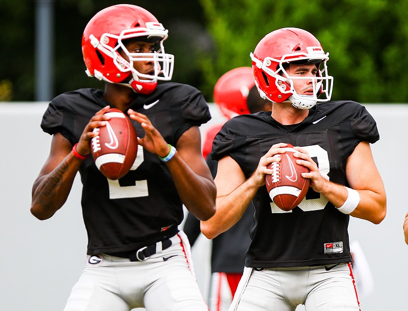 Georgia photo by Tony Walsh / Georgia redshirt freshman quarterback D'Wan Mathis, left, could be the surprise starter for the Bulldogs over Southern California transfer JT Daniels, right.