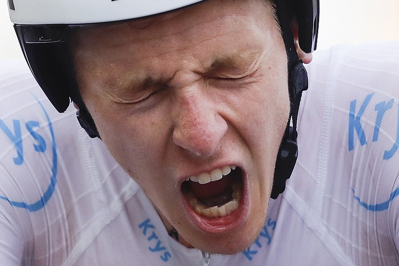 AP photo by Christophe Ena / Tadej Pogacar crosses the finish line for the 20th stage of the Tour de France on Saturday in La Planche des Belles Filles, with his dominant performance in the time trial giving him a stage victory and the overall lead with only Sunday's ceremonial ride into Paris remaining.