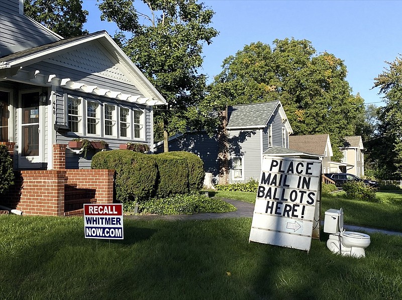 A political display is set up in the lawn of a home in Mason, Mich., seen Friday, Sept. 18, 2020. Barb Byrum, the Democratic clerk of Ingham County, filed a complaint with police over the display, saying it could mislead people who aren't familiar with how mail-in voting works. (Matthew Dae Smith/Lansing State Journal via AP)


