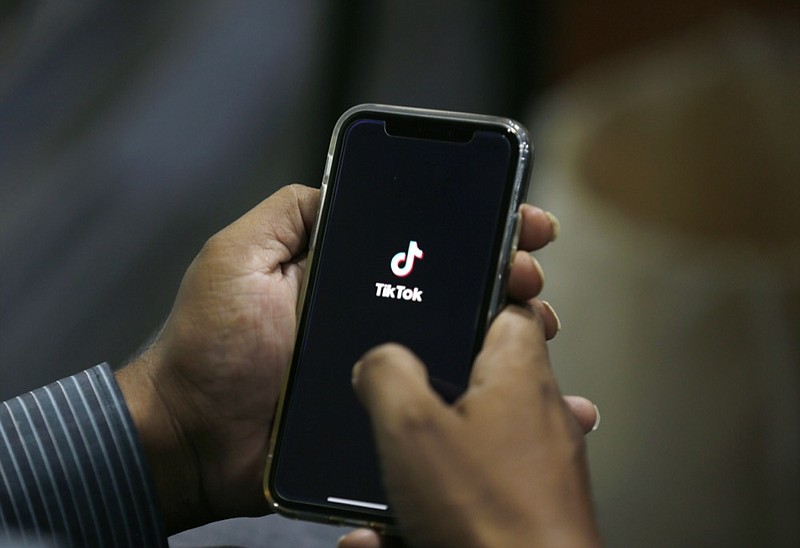 FILE - In this July 21, 2020 file photo, a man opens social media app 'TikTok' on his cell phone, in Islamabad, Pakistan. President Donald Trump said Saturday, Sept. 19, 2020 he's given his "blessing" to a proposed deal between Oracle and Walmart for the U.S. operations of TikTok, the Chinese-owned app he's targeted for national security and data privacy concerns. (AP Photo/Anjum Naveed, File)


