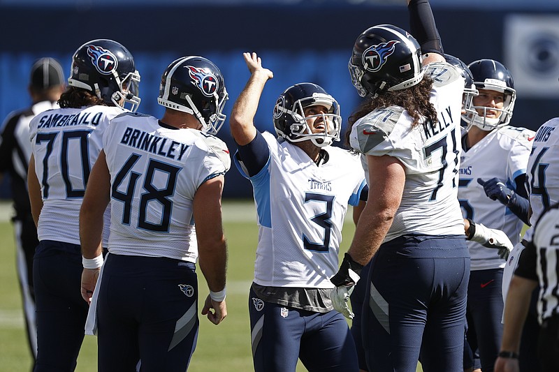 AP photo by Wade Payne / Tennessee Titans kicker Stephen Gostkowski (3) celebrates with offensive lineman Dennis Kelly (71) after kicking a 49-yard field goal late in the team's 33-30 win against the Jacksonville Jaguars on Sunday in Nashville.