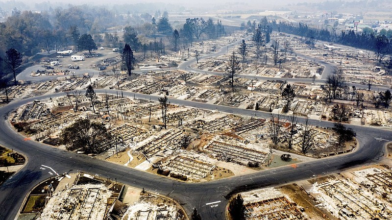 FILE - In this photo taken by a drone, homes leveled by the Almeda Fire line the Bear Lake Estates in Phoenix, Ore., Tuesday, Sept. 15, 2020. The Census Bureau is contending with several natural disasters as wildfires and hurricanes disrupt the final weeks of the nation's once-a-decade headcount. (AP Photo/Noah Berger)