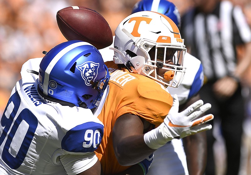 Staff Photo by Robin Rudd/  Tennessee's Ty Chandler (8) fumbles as he is hit by Georgia State's Hardrick Willis (90).  Chandler's turnover lead to the first Panther touchdown.  The University of Tennessee Volunteers opened the season wit the Georgia State Panthers at Neyland Stadium on August 31, 2019.  