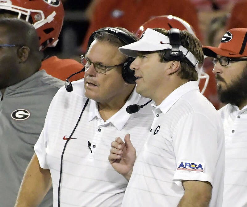 Former Georgia offensive line coach Sam Pittman, left, and current Bulldogs head coach Kirby Smart will be on opposite sidelines Saturday when Pittman makes his debut guiding the Arkansas Razorbacks.