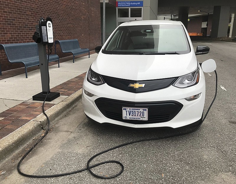 Staff Photo by Robin Rudd/ A Tennessee Valley Authority Chevrolet Bolt charges outside the federal utility's Missionary Ridge office complex on Broad Street .