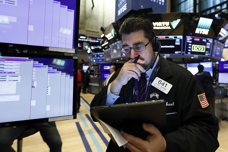 In this Jan. 27, 2020, file photo, trader Michael Capolino works on the floor of the New York Stock Exchange. Wall Street is opening sharply lower Monday, Sept. 21, 2020, led by financial stocks, after a report alleged banks were profiting from illicit dealings with disreputable people and criminal networks. (AP Photo/Richard Drew, FIle)