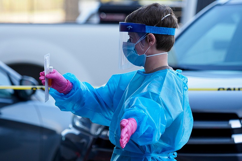 Staff photo by C.B. Schmelter / A worker directs a vehicle before taking a sample at the Alstom COVID-19 testing site on Tuesday, Sept. 22, 2020 in Chattanooga, Tenn.