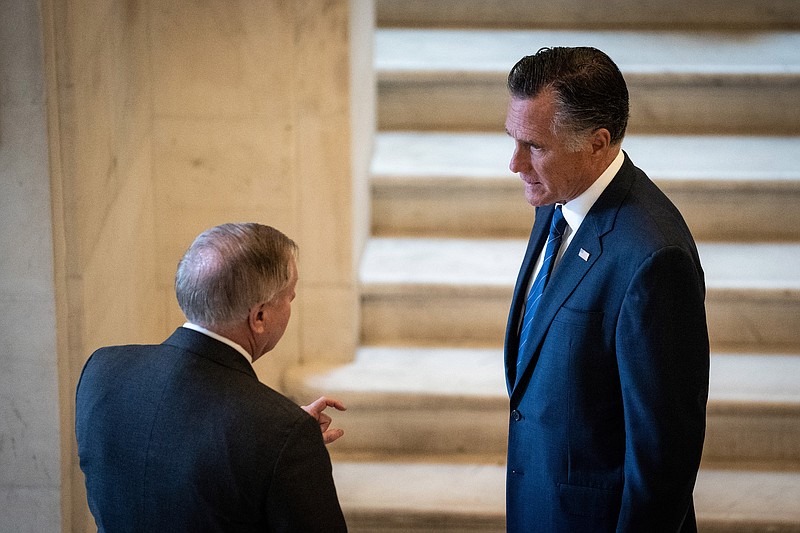 File photo by Erin Schaff of The New York Times / Sen. Lindsey Graham, R-South Carolina, left, talks with Sen. Mitt Romney, R-Utah, on Capitol Hill in Washington on March 18, 2020.