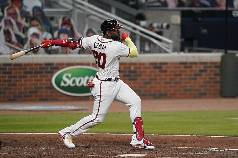 Atlanta Braves' Marcell Ozuna hits a double in the fifth inning of a baseball game against the Miami Marlins on Tuesday, Sept. 22, 2020, in Atlanta. (AP Photo/Brynn Anderson)