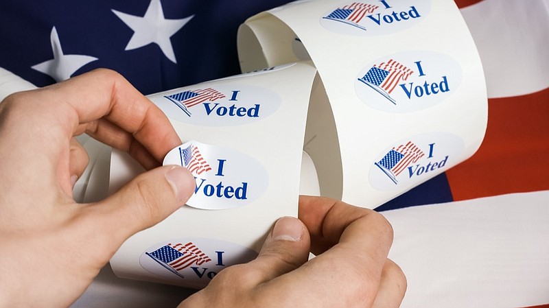 I voted stickers with united states flag with human hands voting tile vote tile ballot election tile / Getty Images
