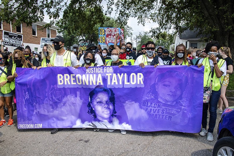 FILE - Protesters participate in the Good Trouble Tuesday march for Breonna Taylor, on Tuesday, Aug. 25, 2020, in Louisville, Ky. A lawyer for Breonna Taylor's family said a plea deal was offered to an accused drug trafficker that would have forced him to implicate Taylor, who was killed by police in a raid on her home in March. Louisville's top prosecutor acknowledged the existence of the document but said it was part of preliminary plea negotiations with a man charged with illegal drug trafficking and not an attempt to smear Taylor.(Amy Harris/Invision/AP File)