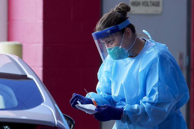 Staff photo by C.B. Schmelter / A worker talks to a patient after taking a sample at the Alstom COVID-19 testing site on Tuesday, Sept. 22, 2020, in Chattanooga, Tenn.