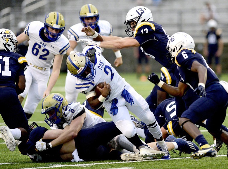 Staff photo by Robin Rudd / Chattanooga Christian School's Luke Bowman (13) knocks Christian Academy of Knoxville running back J.D. Dunn off his feet during Friday night's game at CCS.