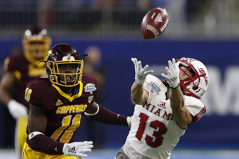 AP photo by Carlos Osorio / Miami (Ohio) wide receiver Jack Sorenson stretches to try to make a catch as Central Michigan defensive lineman LaQuan Johnson looks on during the first half of the Mid-American Conference championship game on Dec. 7, 2019, in Detroit.